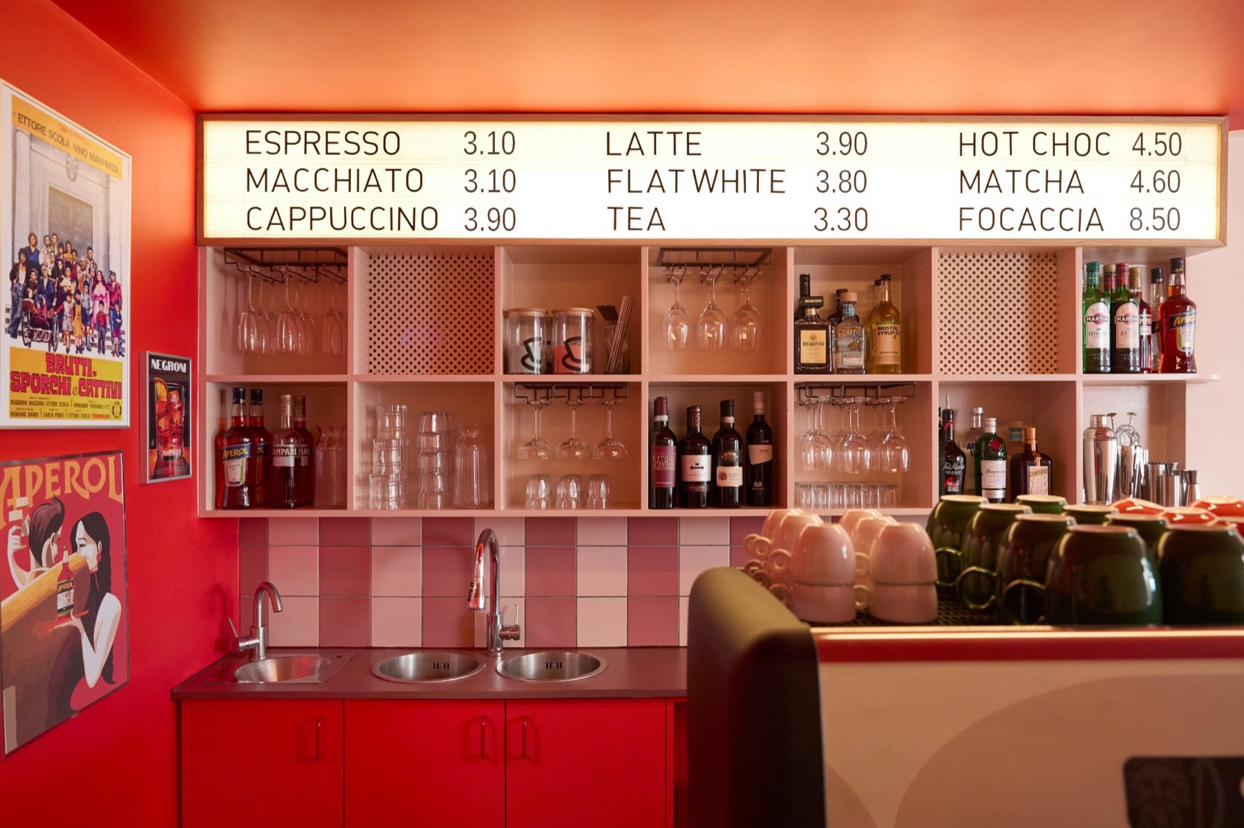 Intervallo aperitivo bar with illuminated menu board and drinks shelf in Deptford London