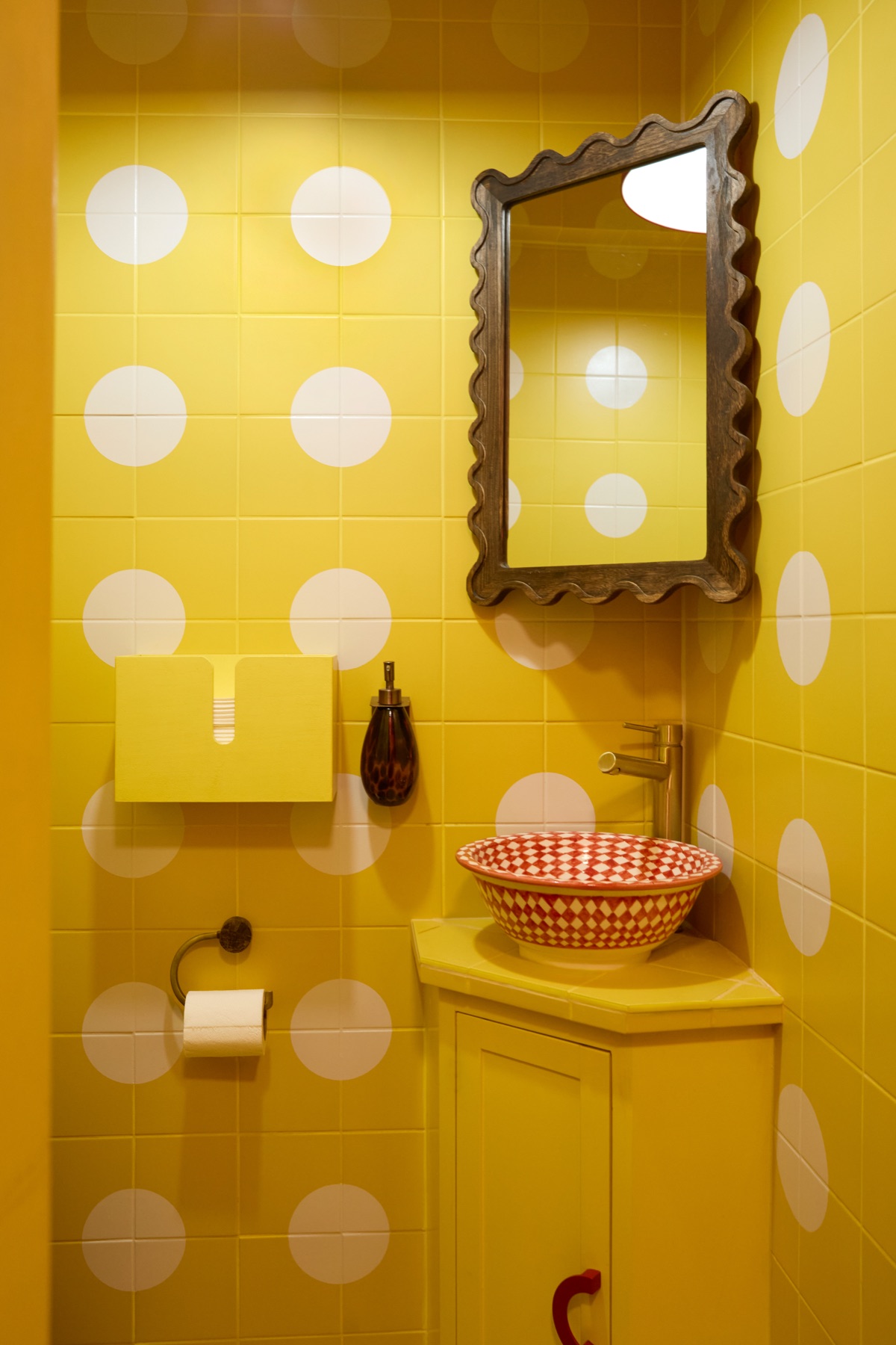 Playful yellow polka dot bathroom interior at Intervallo cafe Deptford London