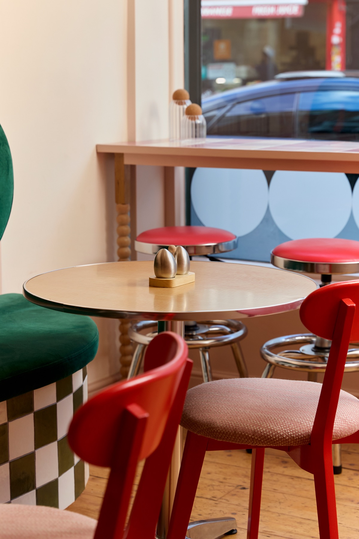 Red chairs and bar stools at window seating in Intervallo Italian cafe Deptford London